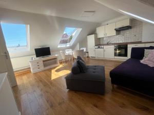a large living room with a couch and a kitchen at Nord11 in Borkum