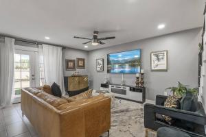 a living room with a couch and a flat screen tv at Spacious Entire Home 4B & 2.5B in Avondale Arizona in Avondale