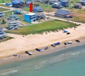 an aerial view of a beach with cars and buildings at Beachfront - Hot Tub - Home Theater in Bolivar Peninsula