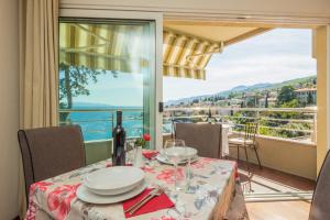a dining room with a table and a view of the ocean at Apartments Villa Dinka in Opatija