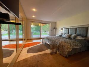 a bedroom with a large bed and a large window at Stylish Host Cantabria- Lujosa villa en Bezana in Santa Cruz de Bezana +53 photos