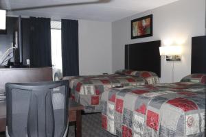 Postel nebo postele na pokoji v ubytování Fort York Motel + 2 fotografie