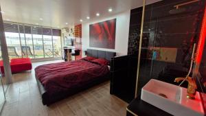 a bedroom with a bed and a bathroom with a tub at Cap sur le Paradis in Cap d'Agde