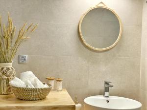 a bathroom with a sink and a mirror at Bamboo House Syros No1 in Ermoupoli