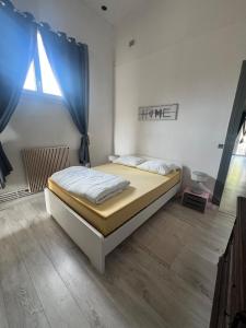 a bedroom with a large bed with blue curtains at Appartement à 50m de la Plage A in Arcachon
