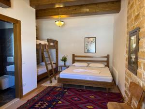 a bedroom with a bed and a ladder in a room at Ana Rest House Hostel Berat in Berat