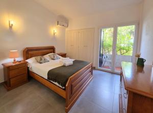 een slaapkamer met een bed en een groot raam bij Villa Alprochinhos in Porches