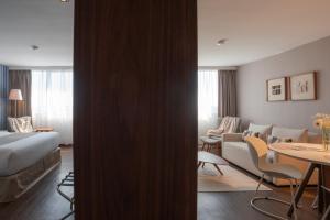 a hotel room with a bed and a living room at Frontier Hotel Rivera in Rivera