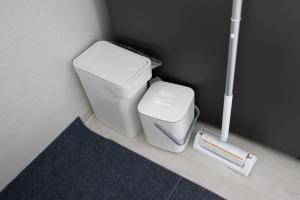 a small bathroom with a toilet and a scale at 4 Beds Busan Gwangalli Big Star Stay in Busan +50 photos