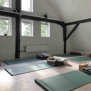 a yoga room with several mats on the floor at Close to nature in cozy old mill in Timmersdala