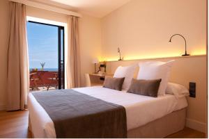 Posteľ alebo postele v izbe v ubytovaní L'Aixart Aiguablava Hotel