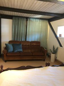a living room with a couch in front of a window at Close to nature in cozy old mill in Timmersdala +48 photos