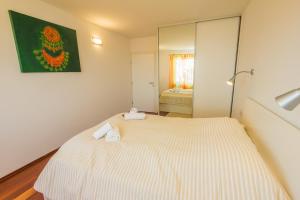 a bedroom with a bed with two towels on it at Apartments Villa Dinka in Opatija