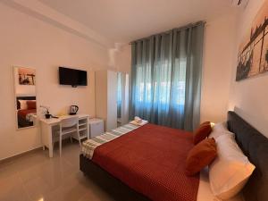 a bedroom with a bed and a table and a window at Casa Duca D'aosta in Venice +31 photos