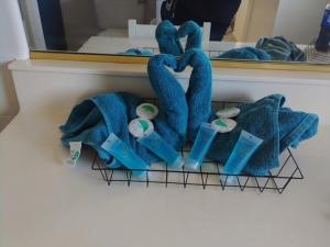 a rack with blue towels in front of a mirror at Massive 4 Bedroom House with Pool in Oroville