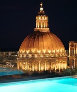 a large building with a tower on top of it at Central Apartment Sliema John in Sliema