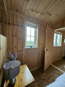 a room with wooden walls and a large window at Shepard's Delight in Lisnaskea +22 photos
