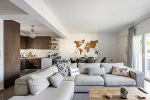 a living room with a couch and a kitchen at The travellers's house in Chalkida