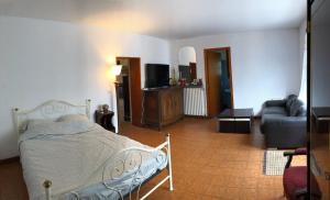 a bedroom with a bed and a living room at Maison calme avec jardin à Gramat in Gramat +19 photos