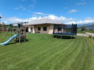 a yard with a slide and a playground at Magnifique Villa Sabot de Venus in Le Lautaret