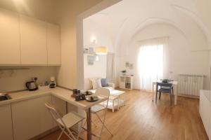 a kitchen and living room with a table and chairs at "CasaMia" Apartment - Brindisi Historic Center in Brindisi