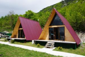 a small house with a red roof at Cottage Harmony in Racha-კოტეჯი ჰარმონია რაჭაში in Ambrolauri