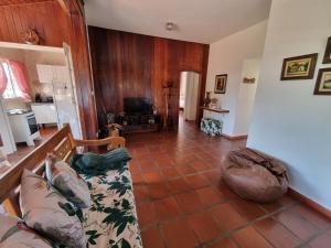 a living room with a couch and a tiled floor at Casa - Águas de São Pedro in Águas de São Pedro