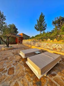 a row of beds sitting on a stone ground at Trifonas village in Karlovasi