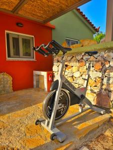 a bike parked in front of a stone wall at Trifonas village in Karlovasi