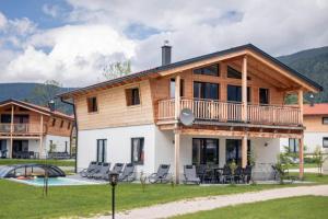 a log home with a deck and a pool at Luxalps- Chalets Inzell- Sauna- Skifahren- Wandern- Natur- Chiemgau Card in Inzell