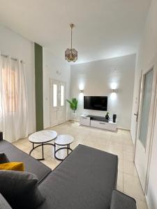 a living room with a couch and a tv at Seaside escape in Symi