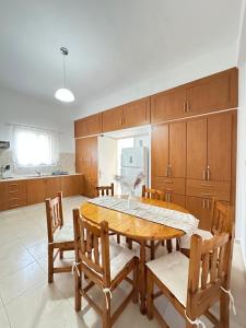 a kitchen with a wooden table and wooden cabinets at Seaside escape in Symi +25 photos