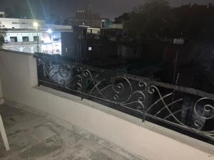 a balcony with a black railing with a view at Golden Triangle in Jāmb