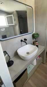 a bathroom with a white sink and a mirror at Kalypso House in Nea Skioni +33 photos