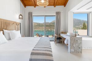 a bedroom with a bed and a desk with a view at Villa Lethia in Yénion +20 photos