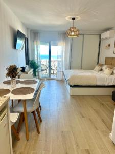a bedroom with a bed and a table and chairs at Apartamento JÚPITER Vistas in Benalmádena +37 photos