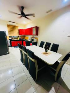 a dining room with a white table and chairs at Homestay Bukit Katil Damai 2 in Ayer Keroh +16 photos