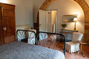 a bedroom with a bed and a table and a chair at Podere Bellavista - Agriturismo Bella Valle in Vada