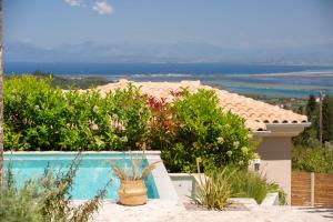 a view of a house with a swimming pool at Veramente Villas With Sea view in Lefkada Town