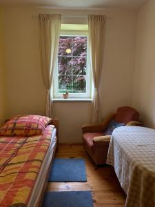 a bedroom with a bed and a window and a couch at Nad Isągiem in Łukta