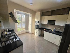 a kitchen with a sink and a stove top oven at Villa Mountain View 4 October in ‘Ezbet `Abd el-Ḥamîd