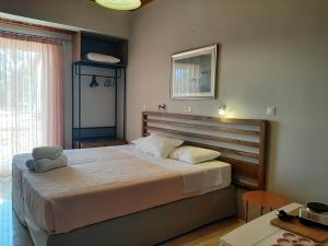 a bedroom with a bed with a stuffed animal on it at George Studios in Vasiliki +37 photos