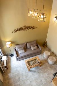 a living room with a couch and a coffee table at Strofilia House Near ATH Airport in Markopoulo +40 photos