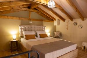 a bedroom with a large bed in a room with wooden ceilings at Strofilia House Near ATH Airport in Markopoulo