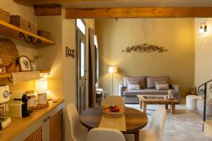 a kitchen and living room with a table and chairs at Strofilia House Near ATH Airport in Markopoulo