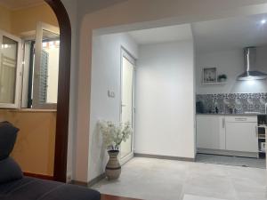 a living room with a vase with flowers in it at Casa Nunes 2 in Pinhão
