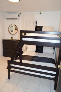 two bunk beds in a room with a mirror at Casa Clemente Vacation Rentals in Carolina +16 photos