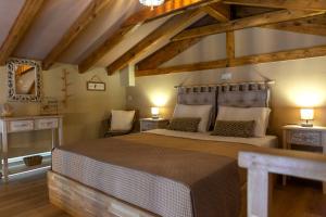 a bedroom with a large bed in a room with wooden ceilings at Strofilia House Near ATH Airport in Markopoulo
