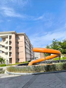 a large orange sculpture in front of a building at Casita Isleta at Cheer Residences in Marilao