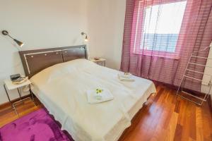 a bedroom with a bed with two towels on it at Apartments Villa Dinka in Opatija +37 photos